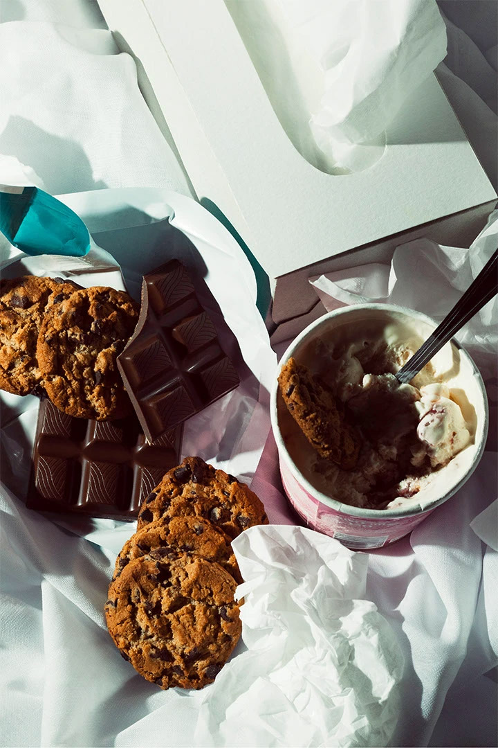 Photography of a messy desk with snacks and tissue paper